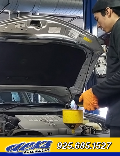 Mechanic servicing vehicle at Dexs Automotive shop in Pacheco, CA